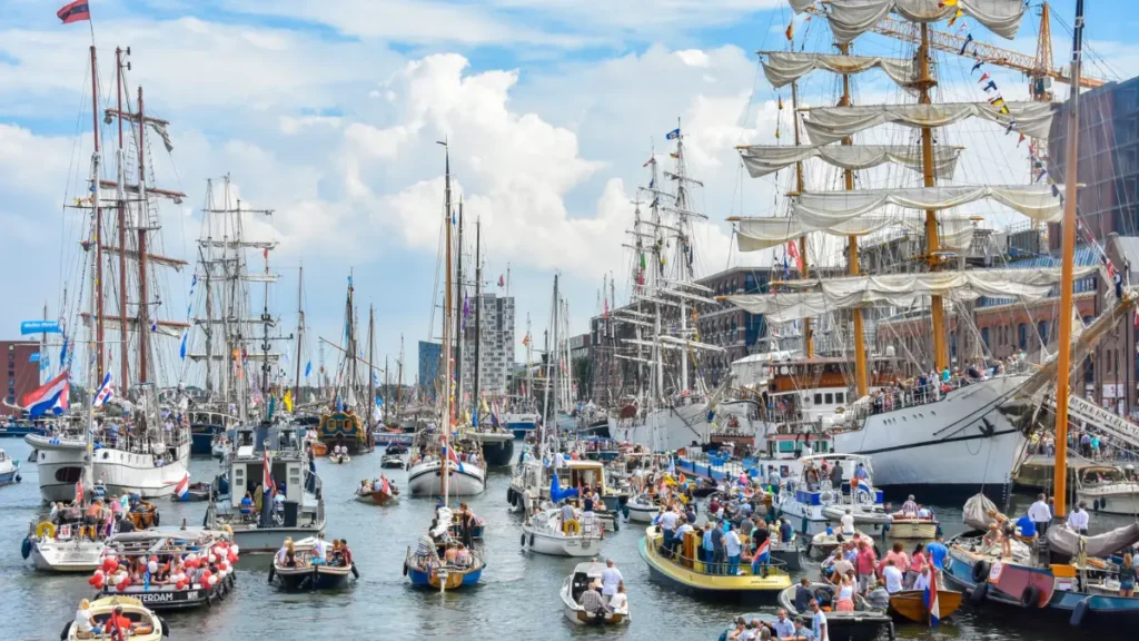 Harbor filled with boats and tall ships during SAIL Amsterdam festival Harbor filled with boats and tall ships during SAIL Amsterdam festival
