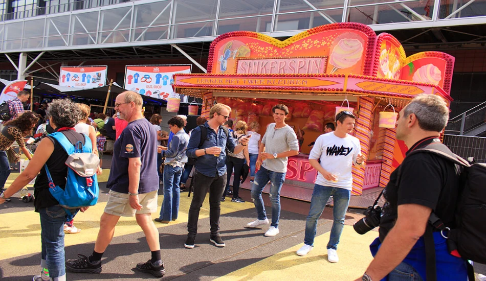Busy food and merchandise zone during Sail Amsterdam celebration.