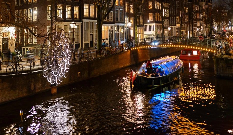 A dark yet lighted and calm atmosphere around the evening cruise boat sailing in the canal.