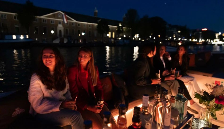Women sitting on a dim lighted cruise in the dark evening backdrop.