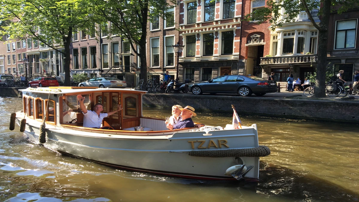 People enjoying a ride in a saloon boat cruise.