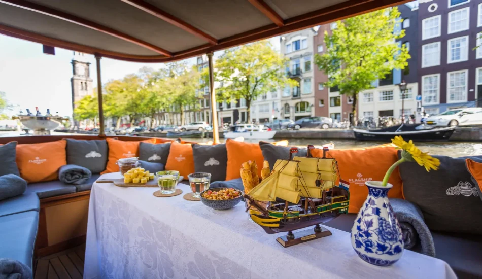 Seats with cushions, snacks and drinks on the table in a boat.